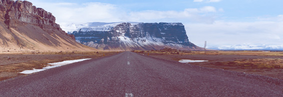 long empty road towards a mountain backdrop